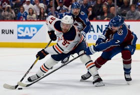 Connor McDavid of the Edmonton Oilers fights for the puck against Devon Toews of the Colorado Avalanche during the first period in Game Two of the Western Conference Final of the 2022 Stanley Cup Playoffs at Ball Arena on June 02, 2022 in Denver, Colorado.  