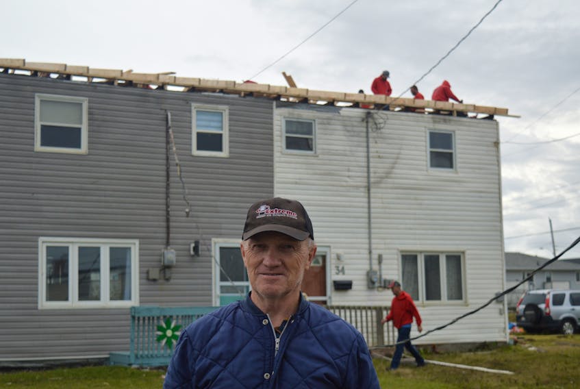 Johnnie Parsons stands outside his home on Ninth Street in the New Aberdeen as work crews replace his roof. Post-tropical storm Fiona ripped the entire stucture from the company house, tossing most of it several hundred feet into a neighbour’s yard and the rest into the Atlantic Ocean. Chris Connors/Cape Breton Post