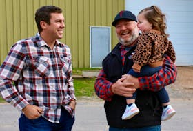 Kings-Hants MP Kody Blois shares a laugh with Rod Corkum and his granddaughter Kinsley Corkum as they waited for the ribbon cutting for the new Spence Hall.