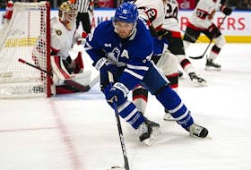 Sep 24, 2022; Toronto, Ontario, CAN; Toronto Maple Leafs forward Alexander Kerfoot (15) controls the puck against Ottawa Senators defenseman Jacob Larsson (32) during the second period at Scotiabank Arena.  