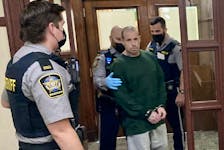 Malcolm Edson Haggerty is escorted out of Halifax provincial court Tuesday after a judge adjourned his sentencing hearing on three charges, including attempting to murder his former domestic partner.