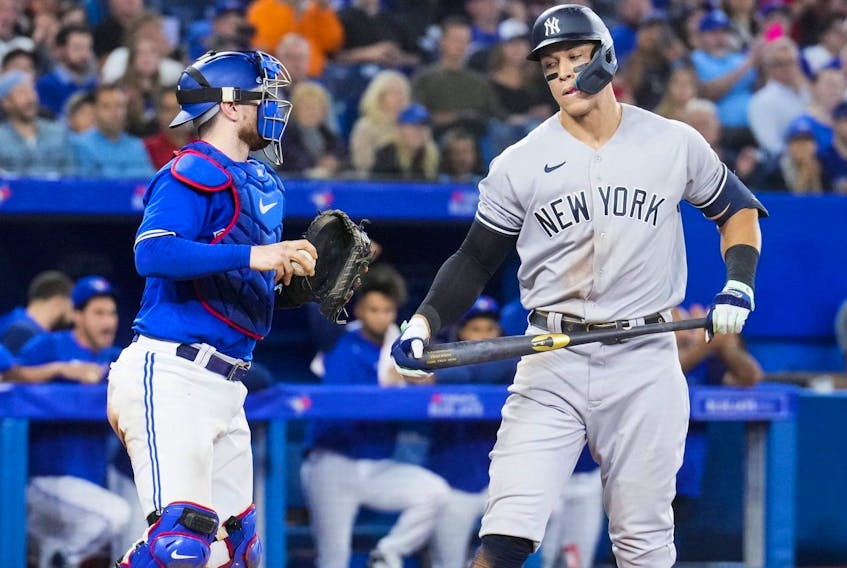 Aaron Judge #99 of the New York Yankees reacts to striking out beside Danny Jansen #9 of the Toronto Blue Jays in the eighth inning during their game on Monday night. 

