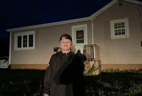 Ben Peterson stands in front of his family's home on Daley Road in New Victoria Monday evening. The family has been without power since early Saturday morning, and like many local residents, are patiently waiting for the lights to come back on. JEREMY FRASER/CAPE BRETON POST.