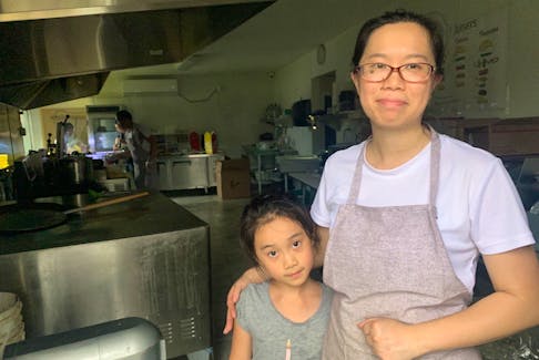 Carol Yang and her daughter Kate stand in the kitchen of Jay’s Chicken and Pizza in Sydney on Tuesday as staff busily prepare warm meals for the public in the aftermath of post-tropical storm Fiona. Yang, who moved to Cape Breton from Shanghai, China, 10 years ago, operates the Jay’s locations in Sydney and Glace Bay. On Monday, they handed out about 1,000 free meals in Glace Bay and another 1,000 in Sydney on Tuesday. Chris Connors/Cape Breton Post