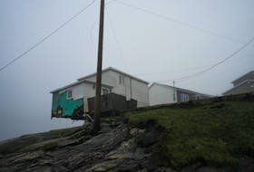 A general view shows a damaged house over an embankment in the aftermath of Hurricane Fiona in Port Aux Basques, Newfoundland, Canada, September 27, 2022. REUTERS/John Morris     TPX IMAGES OF THE DAY  A damaged house teeters over a storm-eroded embankment in the aftermath of Hurricane Fiona in Port Aux Basques, Newfoundland and Labrador on Sept. 27. REUTERS/John Morris