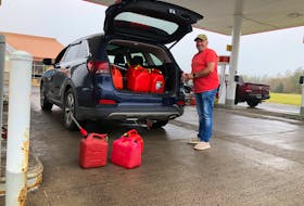 Chris Pickles was spotted filling up gas jugs for himself and his sons at the Membertou Market Shell station on Tuesday morning. Lineups stretched all through the community of Membertou to access both filling stations. GREG MCNEIL/CAPE BRETON POST