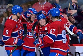 Montreal Canadiens forward Cole Caufield (22) celebrates with teammates, including defenceman Mike Matheson (8) and forward Joshua Roy (97) after scoring a goal against the New Jersey Devils during the first period at the Bell Centre in Montreal on Sept. 26, 2022.