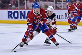 Montreal Canadiens forward Cole Caufield plays the puck as New Jersey Devils forward Andreas Johnsson defends during the first period at the Bell Centre on Monday, Sept. 26, 2022. 