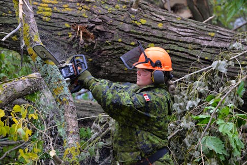 Pte. Emma Bowman, a medic with the 33 Field Ambulance, was responsible for cutting up a large cluster of trees that fell behind Birchwood Intermediate School on Longworth Avenue in Charlottetown. Bowman was one of 34 soldiers tasked with helping with cleanup efforts from post-tropical storm Fiona on Sept. 27. TERRENCE MCEACHERN • THE GUARDIAN