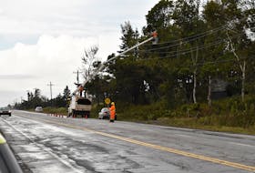 Crews clear branches from power lines along the Trans-Canada Highway in Birch Hill, east of Charlottetown, on Sept. 27. Alison Jenkins • The Guardian