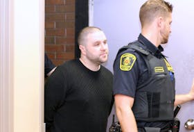 Dominic Delisle escorted into provincial court in St. John’s in 2018. — File photo