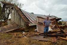 Farmer Ryan Doiron stands in front of what’s left of his barn after post-tropical storm Fiona. Family, friends and members of the community rescued 19 cattle, seven goats, dozens of chickens, one horse and two geese from the wreckage during the severe weather Sept. 24. Alison Jenkins • The Guardian