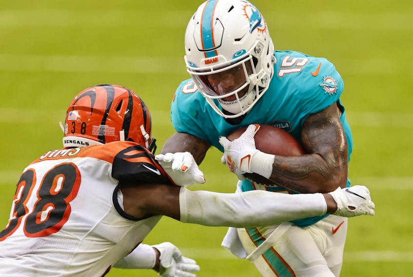 Wide receiver Lynn Bowden Jr. #15 of the Miami Dolphins runs with the ball against cornerback LeShaun Sims #38 of the Cincinnati Bengals in the third quarter of the game at Hard Rock Stadium on December 06, 2020 in Miami Gardens, Florida.