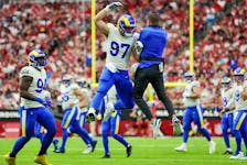 Michael Hoecht #97 of the Los Angeles Rams celebrates with head coach Sean McVay after tipping a punt by the Arizona Cardinals during the first quarter at State Farm Stadium on September 25, 2022 in Glendale, Arizona.