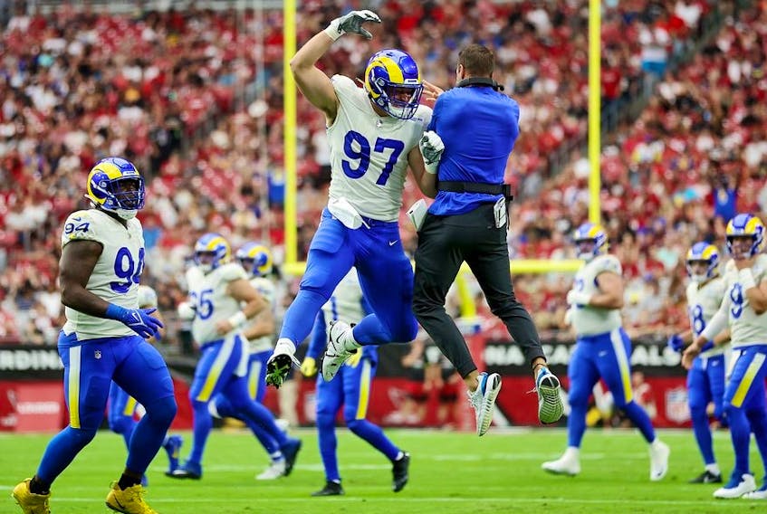 Michael Hoecht #97 of the Los Angeles Rams celebrates with head coach Sean McVay after tipping a punt by the Arizona Cardinals during the first quarter at State Farm Stadium on September 25, 2022 in Glendale, Arizona.