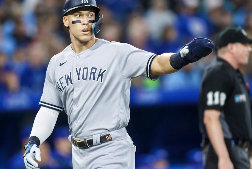 Yankees’ Aaron Judge celebrates as he scores off a Gleyber Torres single in the sixth inning at Rogers Centre last night. Judge walked four times in the game.  