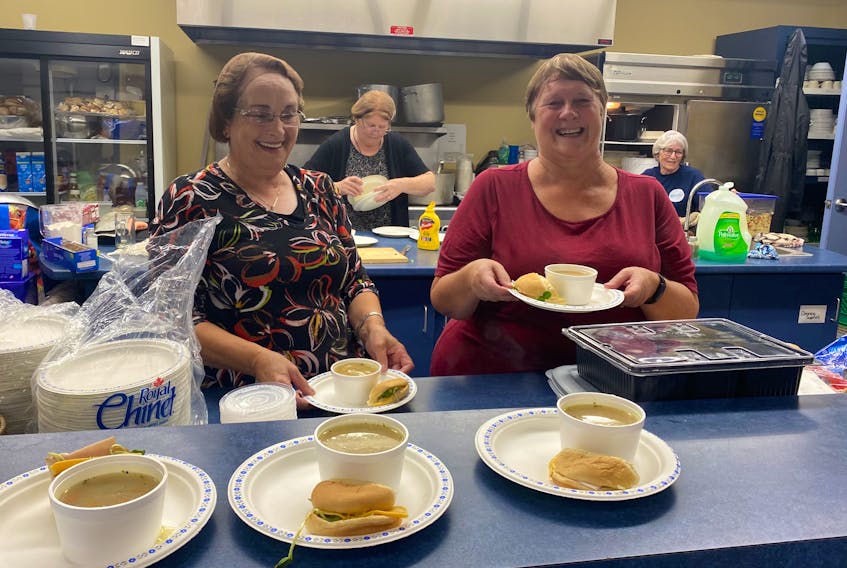 There was plenty of comfort, including hot food and beverages, inside the Louisbourg Volunteer Fire Department's Joseph Trimm Community Centre on Tuesday. The hall is being used as an emergency comfort centre. Above, volunteers Mary Marsdon, left, and Gail Bond prepare to hand out some hot soup, while Jeannie Pearl and Sharon Carter work in the background. DAVID JALA/CAPE BRETON POST