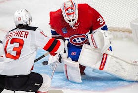 Montreal Canadiens goaltender Jake Allen stops New Jersey Devils' Nico Hischier during first period in Montreal on Sept. 26, 2022.