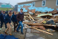 Prime Minister Justin Trudeau (right) tours the Water Street area of Port Aux Basques that was damaged during hurricane Fiona last Saturday, Sept. 24. Accompanying him Wednesday are (from left) Burgeo-La Poile MHA Andrew Parsons, Premier Andrew Furey and St. John's South-Mount Pearl MP Seamus O'Regan. Keith Gosse • The Telegram