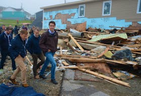 Prime Minister Justin Trudeau (right) tours the Water Street area of Port Aux Basques that was damaged during hurricane Fiona last Saturday, Sept. 24. Accompanying him Wednesday are (from left) Burgeo-La Poile MHA Andrew Parsons, Premier Andrew Furey and St. John's South-Mount Pearl MP Seamus O'Regan. Keith Gosse • The Telegram