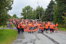 Participants in a National Day for Truth and Reconciliation walk march from the Millbrook Community Hall near Truro, N.S., to the nearby powwow grounds in 2021. File