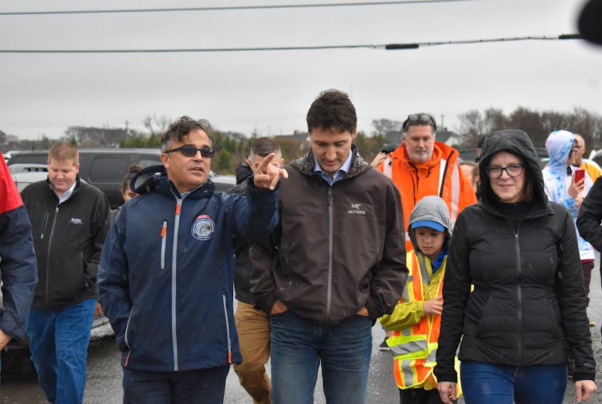 Prime Minister Justin Trudeau, middle, walks up Tenth Street in Glace Bay along with MP Mike Kelloway, left, and Cape Breton Regional Municipality Mayor Amanda McDougall on Tuesday. Trudeau was in Cape Breton to get a firsthand look at the damage caused by post-tropical storm Fiona. JEREMY FRASER/CAPE BRETON POST.