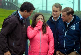 A distraught Amy Osmond describes the night hurricane Fiona destroyed her home to Prime Minister Justin Trudeau (left), MP Seamus O’Regan (second from right) and Premier Andrew Furey, in Port aux Basques Wednesday, Sept. 28. Keith Gosse • The Telegram
