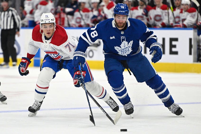 Toronto Maple Leafs defenceman TJ Brodie (78) and Montreal Canadiens forward Jake Evans (71) pursue the puck in pre-season action.