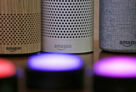 Amazon Echo and Echo Plus devices, behind, sit near illuminated Echo Button devices during an event by the company in Seattle on Sept. 27, 2017. 