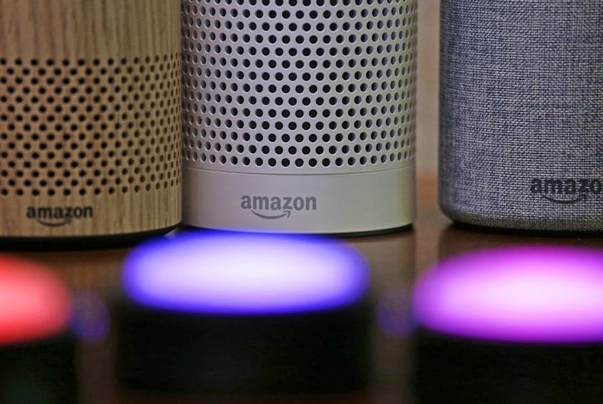 Amazon Echo and Echo Plus devices, behind, sit near illuminated Echo Button devices during an event by the company in Seattle on Sept. 27, 2017. 