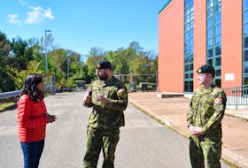 Lt. Col. Adam Poirier, centre, talks with Defence Minister Anita Anand outside the Pictou Armouries on Sept. 29.
