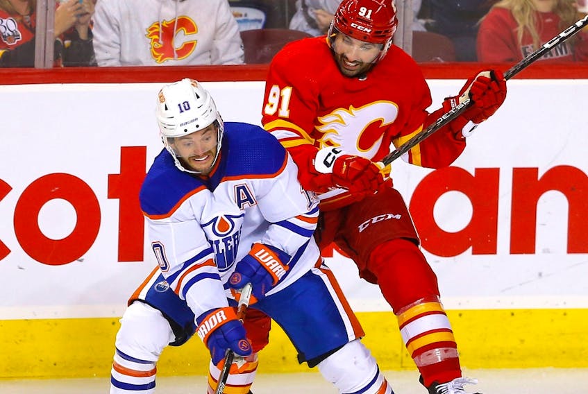 Calgary Flames forward Nazem Kadri battles Edmonton Oilers forward Derek Ryan at the Scotiabank Saddledome in Calgary on Wednesday, Sept. 28, 2022.