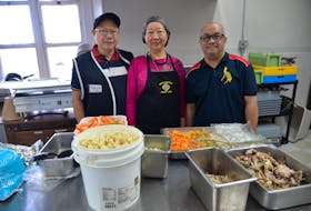 Raymundo Yu, left, his wife Marilyn Yap-Yu and Conrado Soriano III inside the kitchen at the St. Dunstan's Basilica Parish in Charlottetown on Sept. 29. Along with some Filipino Holland College students, they helped prepare and serve roughly 300 meals to people in need at the Confederation Centre of the Arts on Sept. 26. TERRENCE MCEACHERN - THE GUARDIAN