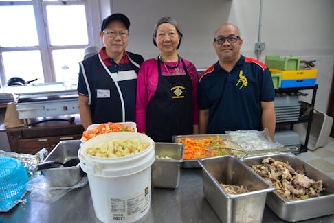 Raymundo Yu, left, his wife Marilyn Yap-Yu and Conrado Soriano III inside the kitchen at the St. Dunstan's Basilica Parish in Charlottetown on Sept. 29. Along with some Filipino Holland College students, they helped prepare and serve roughly 300 meals to people in need at the Confederation Centre of the Arts on Sept. 26. TERRENCE MCEACHERN - THE GUARDIAN