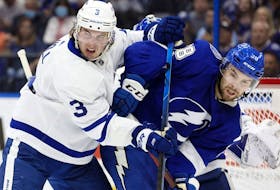 Apr 21, 2022; Tampa, Florida, USA;Toronto Maple Leafs defenseman Justin Holl (3) and Toronto Maple Leafs defenseman Rasmus Sandin (38) fight to control the puck during the second period at Amalie Arena. 