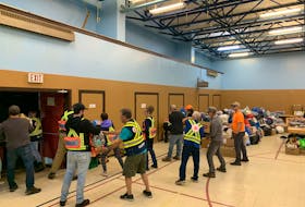 Volunteers including from the Bay of Islands Search and Rescue team line up to offload supplies delivered at the Corner Brook Salvation Army gymnasium on Sept. 28. These supplies will be delivered to Port aux Basques as they are needed. CONTRIBUTED
