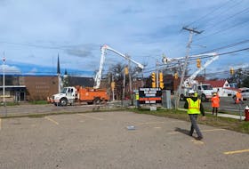 Crews from Central Maine Power work on power poles at the corner of George and Dorchester streets in downtown Sydney on Thursday. CHRIS CONNORS/CAPE BRETON POST