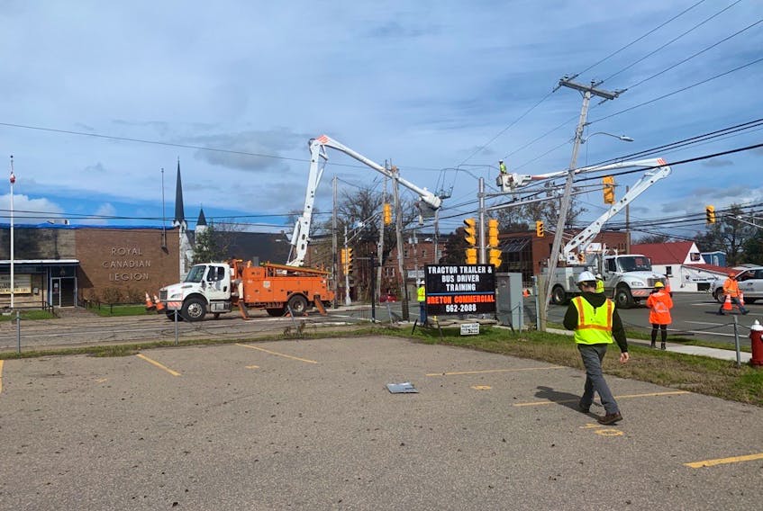 Crews from Central Maine Power work on power poles at the corner of George and Dorchester streets in downtown Sydney on Thursday. CHRIS CONNORS/CAPE BRETON POST