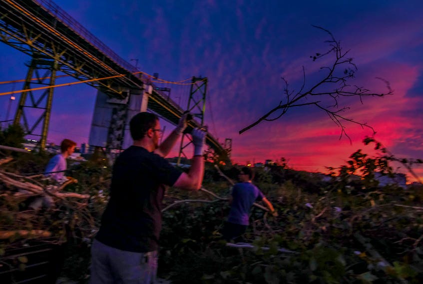 FOR FIONARAMA COVERAGE:
Brad Hirtle tosses a branch into the pille, as resdients pull up drop off their cut up branches and trees to a lot near the Macdonald Bridge, as they dispose of the fallen trees from Fiona's weekend blast,  in Darymouth Wednesday September 28, 2022.

TIM KROCHAK PHOTO