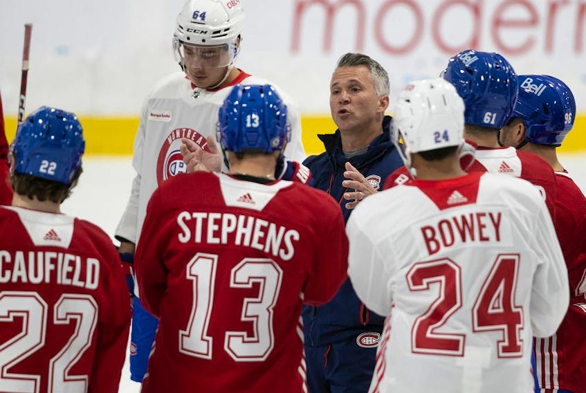 Montreal Canadiens head coach Martin St-Louis talks with his players during first day of training camp in Brossard on Sept. 22, 2022.