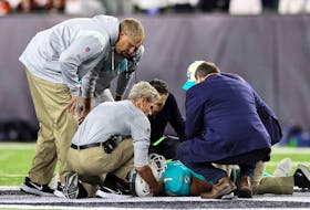Medical staff tend to quarterback Tua Tagovailoa #1 of the Miami Dolphins after an injury during the 2nd quarter of the game against the Cincinnati Bengals at Paycor Stadium on Sept. 29.