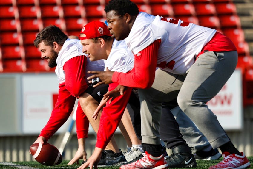 Calgary Stampeders offensive linemen Sean McEwen, Zack Williams and Josh Coker during the walkthrough as the team gets set to play the Toronto Argonauts Saturday at McMahon Stadium in Calgary. 