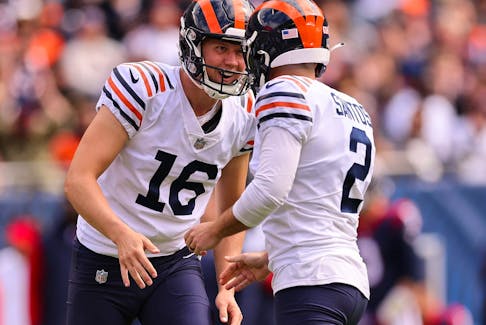 Cairo Santos #2 of the Chicago Bears celebrates with Trenton Gill #16 after kicking a field goal against the Houston Texans at Soldier Field on September 25, 2022 in Chicago, Illinois. 