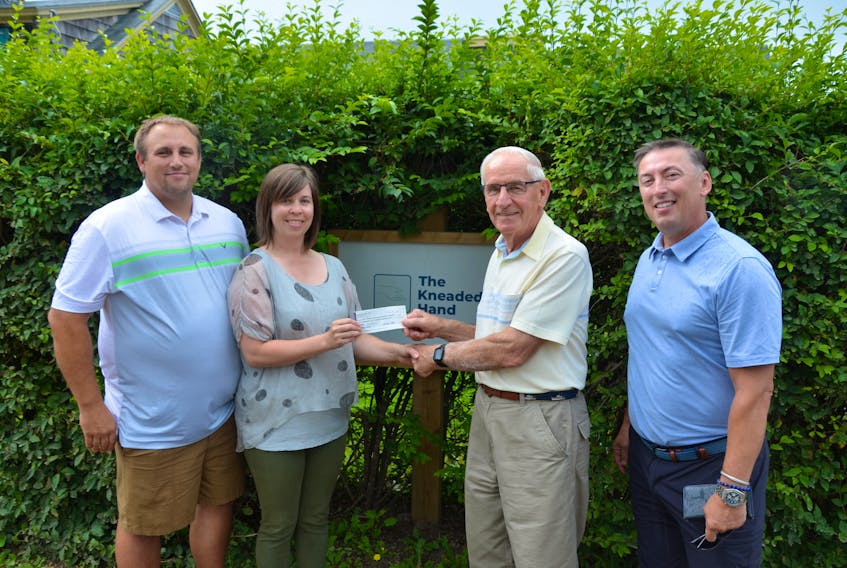 Chris Jagt and owner Amber Jagt of The Kneaded Hand Massage Therapy present a cheque to vice-president Dave Davies and treasurer Bernard Miles of the Halls Harbour Community Development Association. The money will go toward a comprehensive community planning project to help address impacts of the climate crisis and sea level rise in Halls Harbour. KIRK STARRATT
