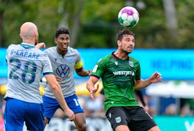 Cavalry FC midfielder Joseph Di Chiara heads the ball while being defended by the HFX Wanderers' Andre Rampersad and Jeremy Gagnon-Lapare during Canadian Premier League play Monday afternoon at the Waanderers Grounds. - TREVOR MacMILLAN / CANADIAN PREMIER LEAGUE