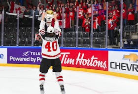 Stellarton's Blayre Turnbull celebrates with the championship trophy after Canada's 2-1 win over the United States in the final of the IIHF world women's hockey championship. - IIHF
