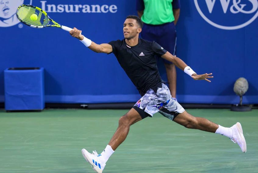 Félix Auger-Aliassime of Canada hits a return to Borna Coric of Croatia during the Western and Southern Open on Aug. 19, 2022, in Mason, Ohio.