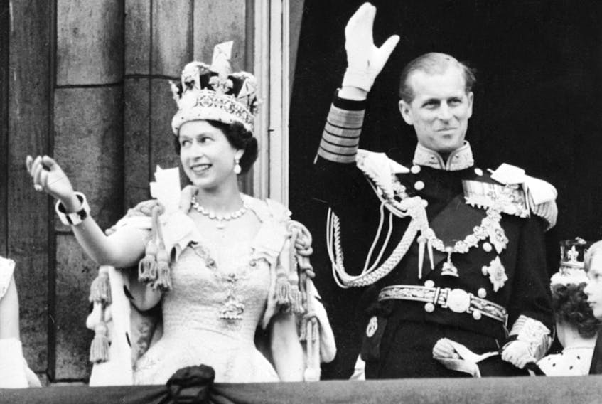 (FILES) In this file photo taken on June 2, 1953 Britain's Queen Elizabeth II (L) accompanied by Britain's Prince Philip, Duke of Edinburgh (R) waves to the crowd, June 2, 1953 after being crowned at Westminter Abbey in London. - Queen Elizabeth II's 99-year-old husband Prince Philip, who was recently hospitalised and underwent a successful heart procedure, died on April 9, 2021, Buckingham Palace announced. (Photo by - / INTERCONTINENTALE / AFP) (Photo by -/INTERCONTINENTALE/AFP via Getty Images)