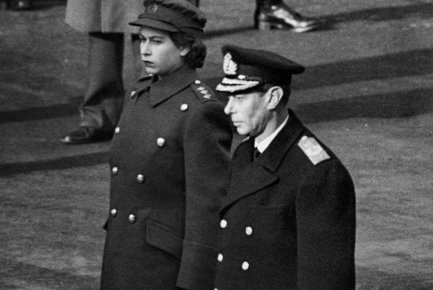 Princess Elizabeth of York and King George VI in ATS uniform stand at the Cenotaph during the first time armistice ceremony since 1938, on November 11, 1945, in London. (Photo by PLANET NEWS / AFP) (Photo by -/PLANET NEWS/AFP via Getty Images)