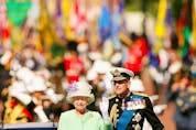 LONDON, UNITED KINGDOM - JULY 10:  HM Queen Elizabeth II, The Queen, and Prince Philip, Duke of Edinburgh, return to watch the flypast over The Mall of British and US World War II aircraft from the Buckingham Palace of balcony on National Commemoration Day July 10, 2005 in London.  Poppies were dropped from the Lancaster Bomber of the Battle Of Britain Memorial Flight as part of the flypast.  (Photo by Daniel Berehulak/Getty Images)